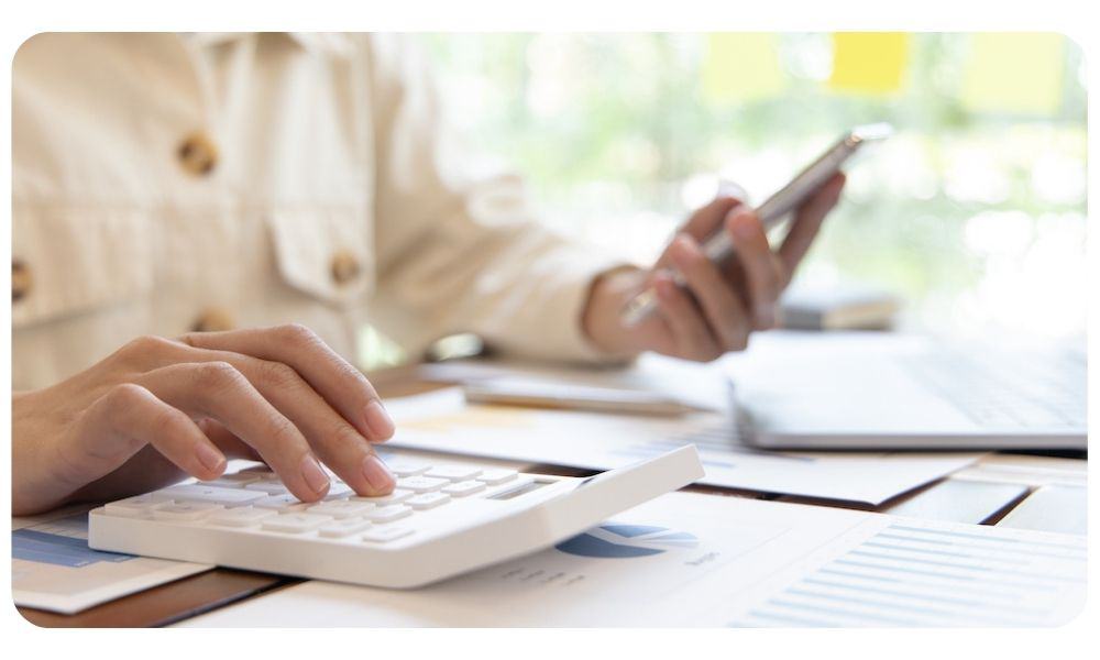 Financial businesswomen use laptop and smart phone to analyze marketing strategies and real estate data to reduce company taxes for their customers, Accounting and Tax concept.